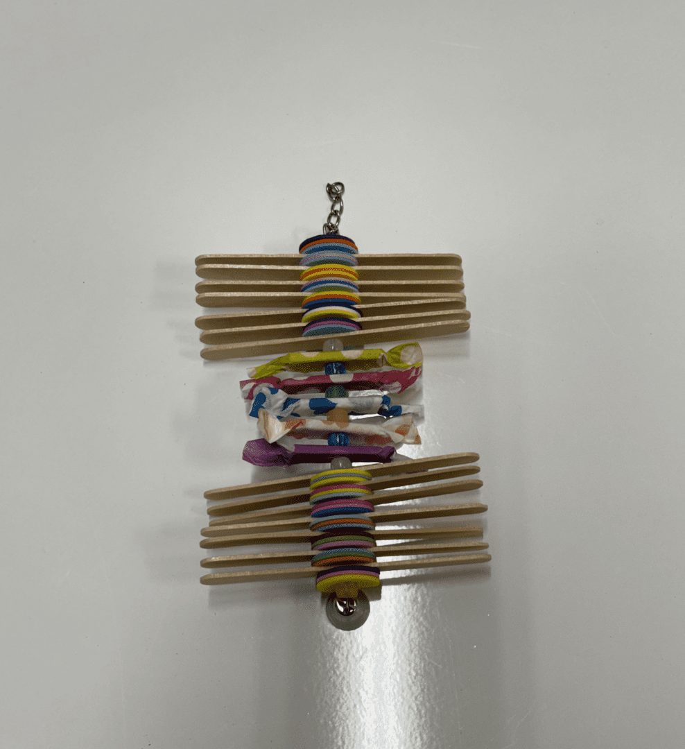 A Candy Pop necklace with colorful beads and sticks on a white surface.